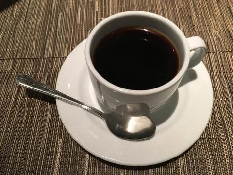Cup of coffee with spoon Stock Photos