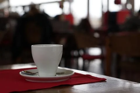 Cup of coffee with spoon on table Foto stock