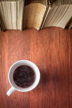 Cup of coffee with stack of old books Stock Photos