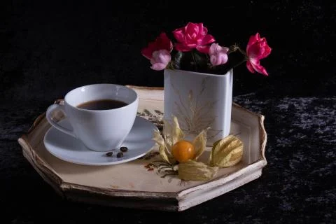 A cup of coffee is standing on a tray. Stock Photos