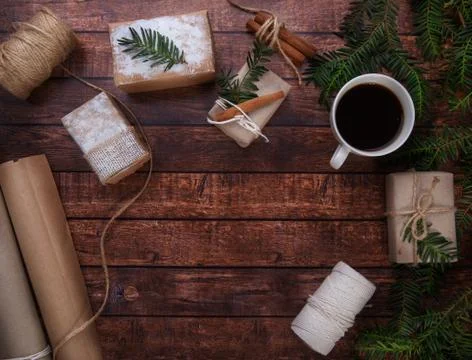 A cup of coffee stands on the table next to Christmas gifts Stock Photos