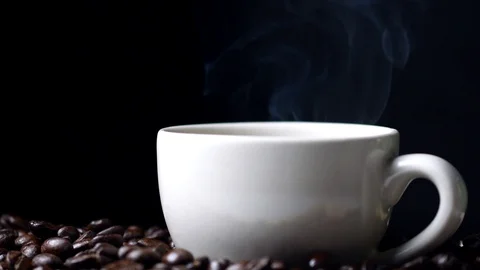 Cup of coffee with steam on black background, hot drink Stock Footage 97378540