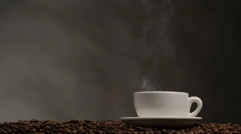 Cup of coffee with steam. Dark background with coffee beans Video stock 65455648