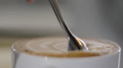 Stir the hot coffee in a cup with a spoo, Stock Video