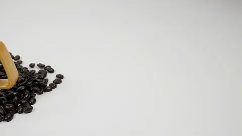 A cup of coffee surrounded by coffee beans on white background. Stock Footage 100796557