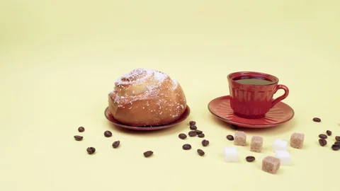 Cup of coffee, sweet bread, sugar cubes and coffee beans. 스톡 동영상 129076120