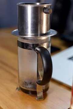 Cup of coffee on the table. brewing coffee using phin filter. it is traditional Stock-Fotos