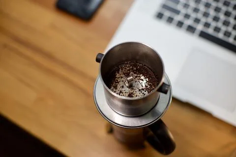 Cup of coffee on the table. brewing coffee using phin filter. it is traditional Foto stock