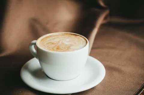 Cup of coffee on table in cafe Stock Photos
