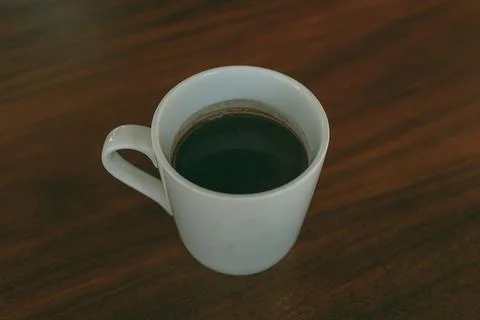 Cup of coffee on the table in the cafe. Photos