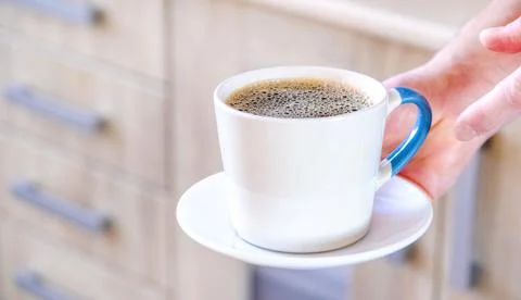 Cup of coffee on the table. Coffee with cream. Sticker and pencil. Stock Photos