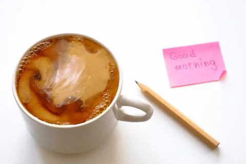 Cup of coffee on the table. Coffee with cream. Sticker and pencil. Stock-Fotos