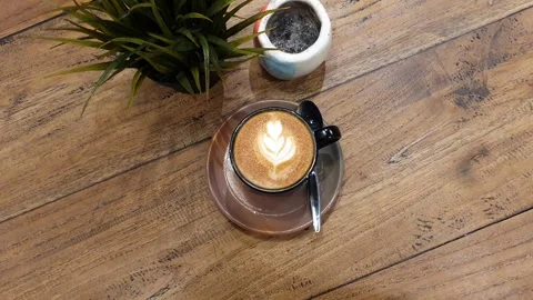 Cup of coffee on a table. cup off cappucino coffee on a table Stock Footage 279295215