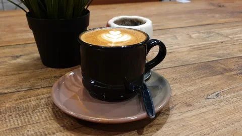 Cup of coffee on a table. cup off cappucino coffee on a table. Video stock 279295226