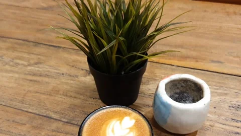 Cup of coffee on a table. cup off cappucino coffee on a table Stock Footage 279295243