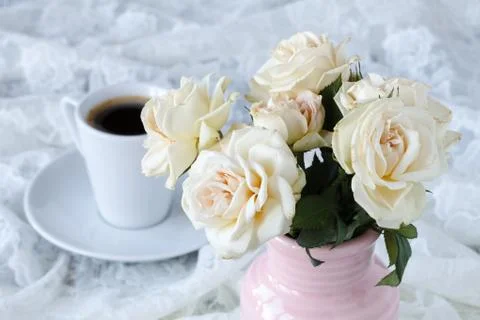 Cup of coffee on a table with flowers Stock Photos