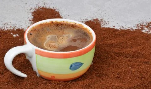 A cup of coffee on the table in the middle of the coffee. Stock Photos