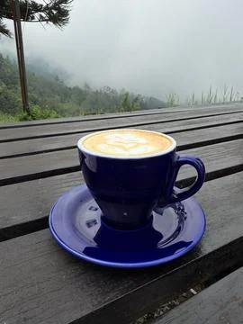 A cup of coffee on the table with mountain background Stock Photos