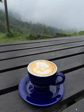 A cup of coffee on the table with mountain background Stock Photos