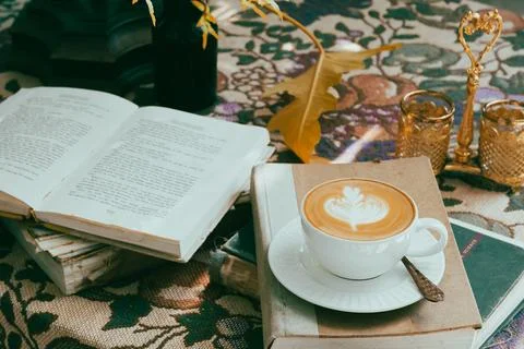 A cup of coffee on the table with notebook-vintage filter Stock Photos