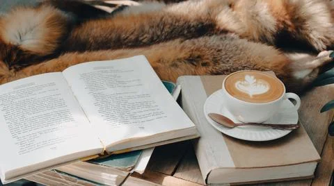 A cup of coffee on the table with notebook-vintage filter Stock Photos
