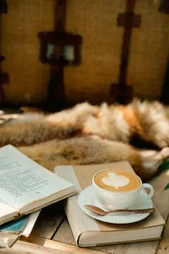 A cup of coffee on the table with notebook-vintage filter Stock Photos
