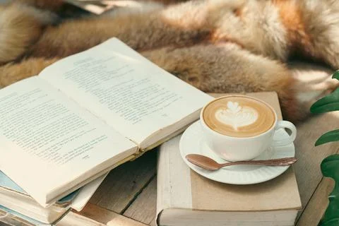 A cup of coffee on the table with notebook-vintage filter Stock Photos