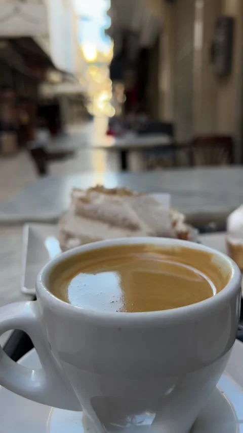 Cup of coffee on table of outdoor terrace cafe in Spain. Vertical video Stock Footage 240920272