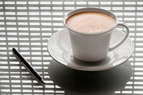 Cup of coffee on the table with the pen Stock Photos