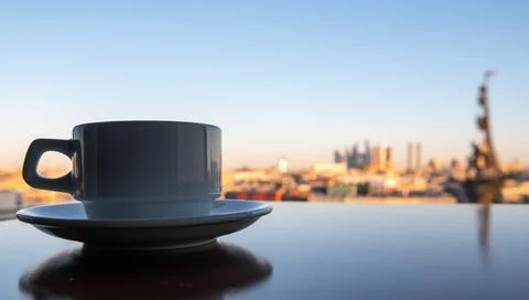 A cup of coffee on a table in a summer cafe with a panoramic view of the cent Stock Photos