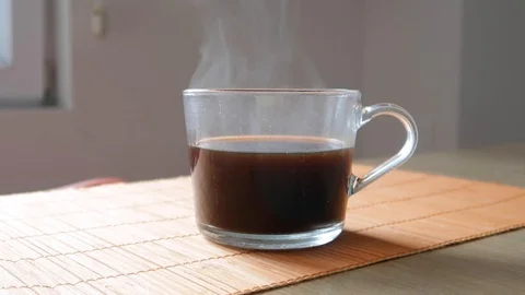 Cup of coffee on the table with swaying steam Stock Footage 106506405