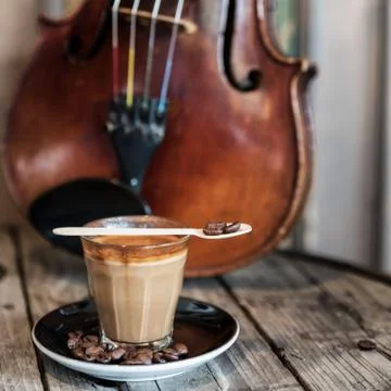 Cup of Coffee on the table with the violin Stock Photos