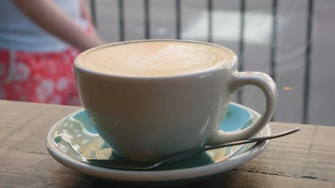 A cup of coffee on a table by a window in a cafe. Stock Footage 91016241