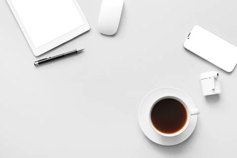 Cup of coffee, tablet computer and mobile phone on grey background Stock Photos