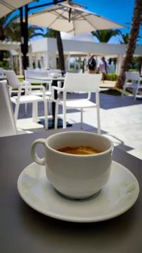Cup of coffee on a terrace table Stock Photos
