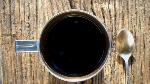 Cup with coffee top view. A cup of coffee is standing on the textured old board. Stock-Footage 115701880