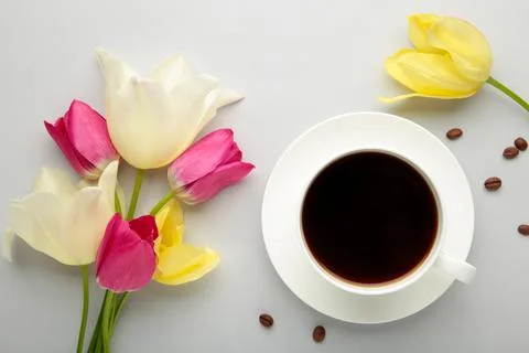 Cup of coffee with tulips on grey background Stock Photos