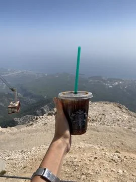 A cup of coffee with a view of the funiculars in the sky Stock Photos