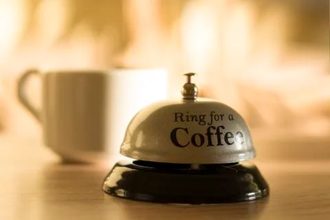 A cup of coffee. Wake up. Steaming coffee cup on a background of sunbeams, co Stock Photos