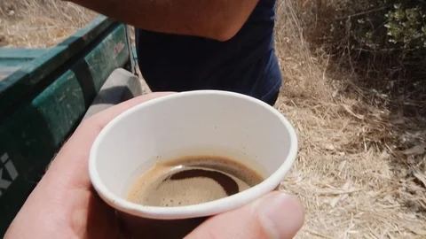 Cup of coffee while working in the field, Summer in Israel, Israeli black coffee Stock Footage 93537187
