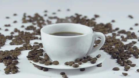 Cup of coffee on white background with seeds Stockbeeldmateriaal 83639489
