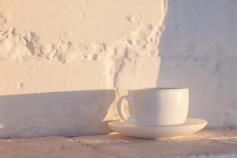 Cup of coffee on white brick background Foto stock