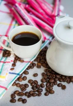 A cup of coffee with white jug and coffee beans Stock Photos