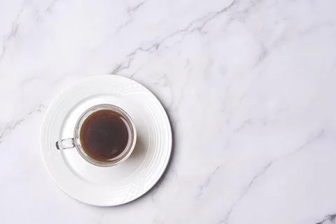 A cup of coffee on a white plate on a Stock Photos