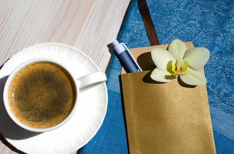 A cup of coffee on a white table. Stock Photos