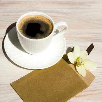 A cup of coffee on a white table. Stock Photos