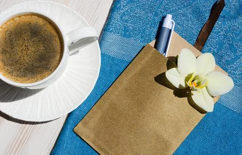 A cup of coffee on a white table. Stock Photos
