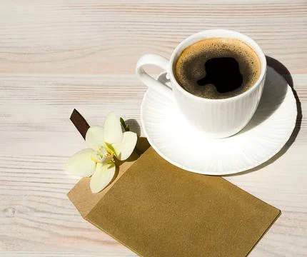A cup of coffee on a white table. Stock Photos