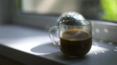 Cup of coffee on window. Morning coffee in light from window. Stock Footage 209003751