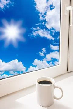 Cup of coffee on the window sill Stock Photos